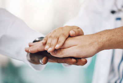 Midsection of couple holding hands