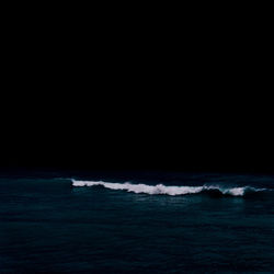 Scenic view of sea against sky at night