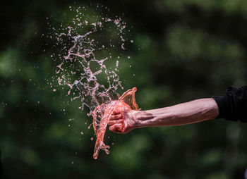 Hand with drinking water pours water. the conditions of the water and environmental crisis