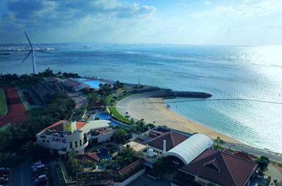 High angle view of swimming pool by buildings against sky