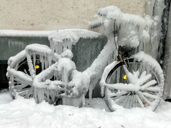 Snow covered bicycle on field