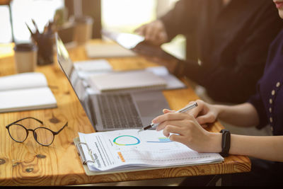 Midsection of business colleagues working at office