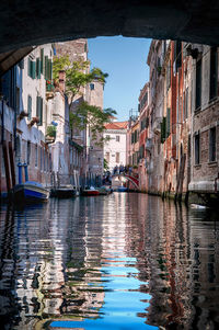 Canal amidst buildings in city