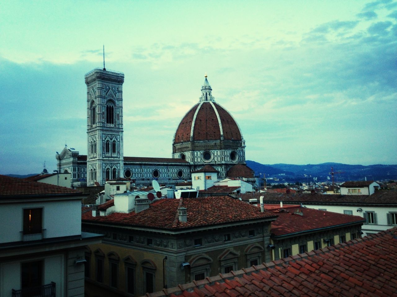 building exterior, architecture, built structure, place of worship, religion, spirituality, church, cathedral, dome, sky, roof, cloud - sky, city, travel destinations, cloud, famous place, steeple, tower