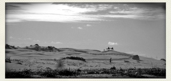 Scenic view of mountains against cloudy sky