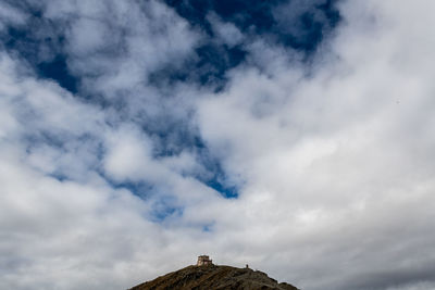 Low angle view of building against cloudy sky