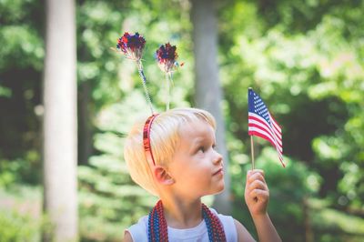 Close-up of girl holding american flag during independence day
