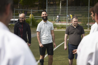 Men participating in sports competition in sports field