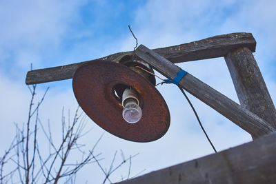 Low angle view of old machinery against sky