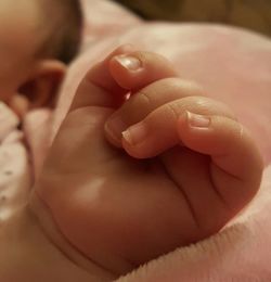 Low section of baby feet on bed