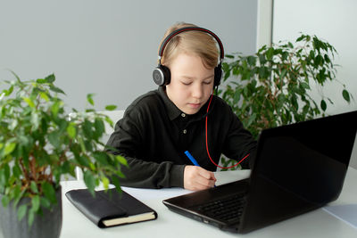 Young woman using laptop at home