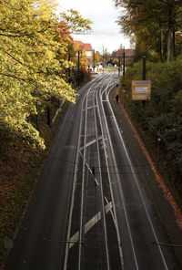 View of railroad tracks by road in city