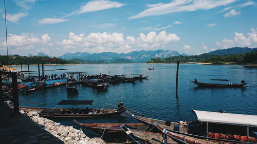 Boats moored in sea against sky