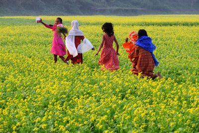 Rear view of children on field