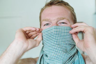 Close-up portrait of man holding hands at home