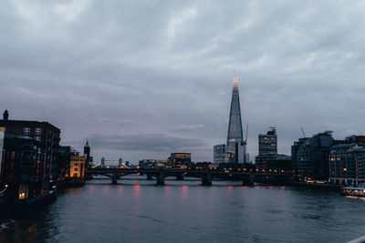 Bridge over river with buildings in background