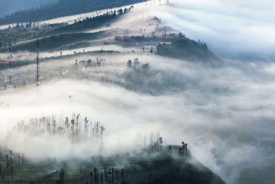 The mist cover the village at bromo volcano mountain in tengger semeru national park,  indonesia