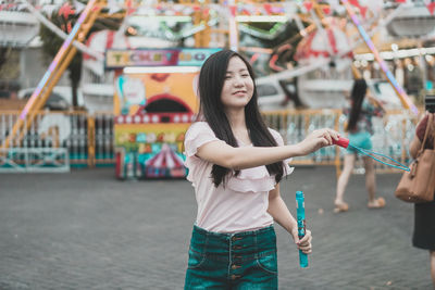 Full length of woman standing in amusement park