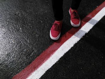 Low section of man standing on road