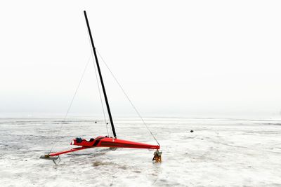 Sailboat in sea against clear sky