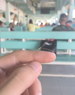 Close-up of hand holding cigarette