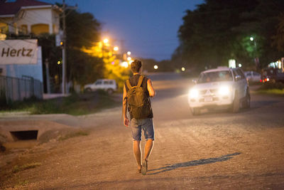 People on illuminated road at night