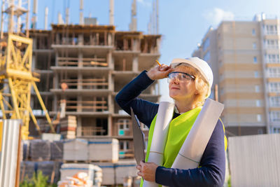 Portrait of man wearing hat at construction site