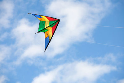 Low angle view of kite flying against sky