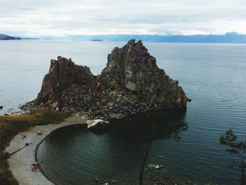 High angle view of rock formation in sea against sky