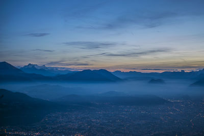 Scenic view of mountain range against blue sky