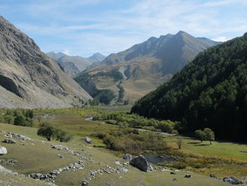 Scenic view of landscape and mountains against sky