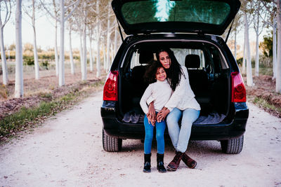 Full length of woman in car