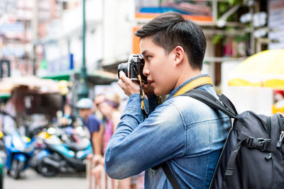 Side view of man photographing