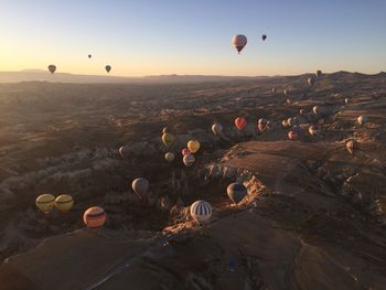 Hot air balloons flying over land
