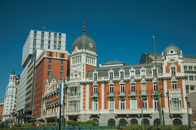 Low angle view of buildings against blue sky