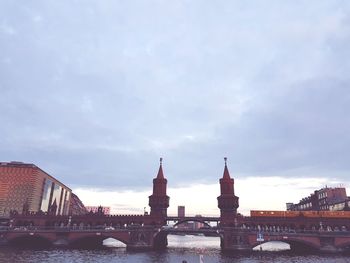 View of bridge over river against cloudy sky