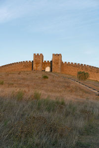 Old ruin on field against sky