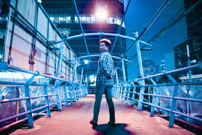 Full length of a man standing in illuminated city