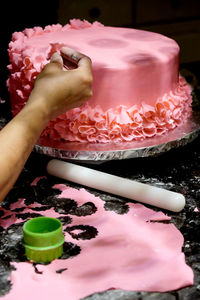 Midsection of woman with chocolate cake