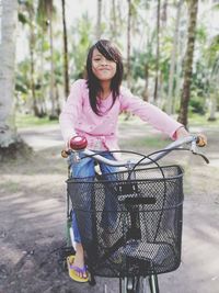 Portrait of woman riding bicycle on basket