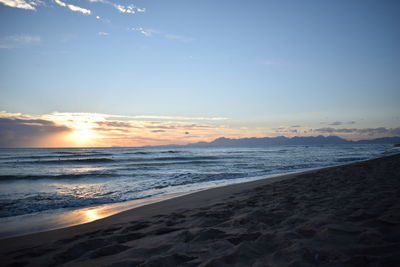 Scenic view of beach against sky during sunset