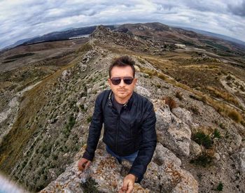 Man standing on mountain against sky