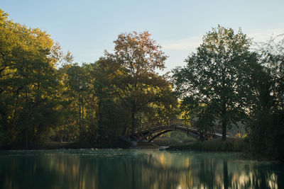 Arch bridge over river against sky