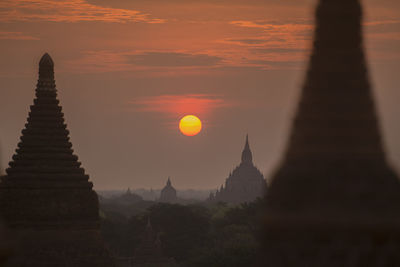 Historic stupas against sky during sunset