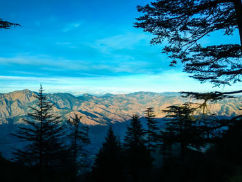 Scenic view of snow covered mountains against sky