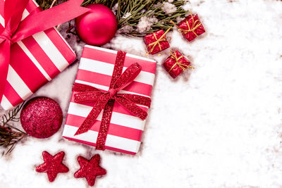 High angle view of christmas gifts on snow