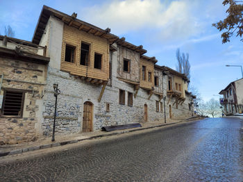 Street amidst buildings against sky in city