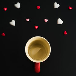Directly above shot of drink over black background