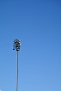 Low angle view of floodlight against clear blue sky