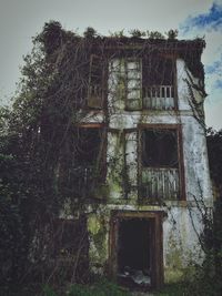 Low angle view of abandoned building against sky